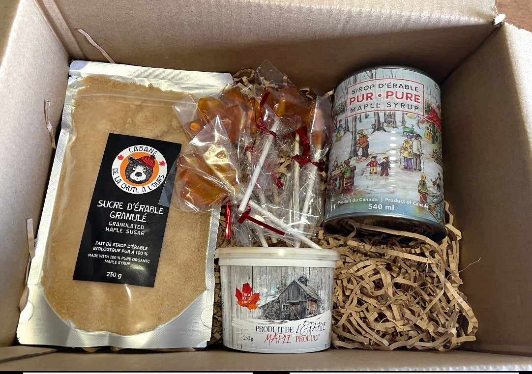 The Ultimate Maple Christmas Gift Box - open gift box showing granulated maple sugar, maple lollipops, maple butter and pure maple syrup tin nestled in kraft paper shred